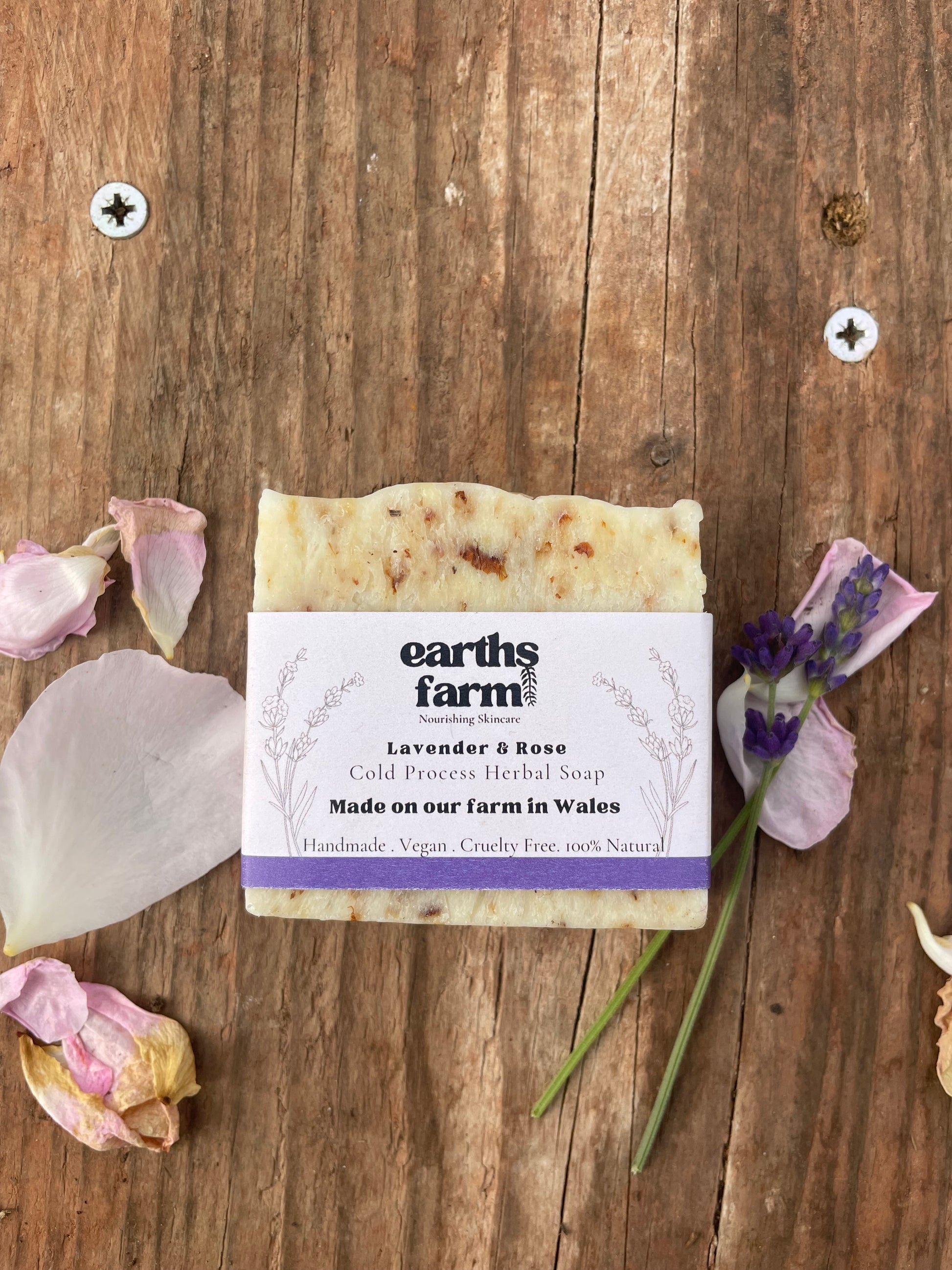 Bar of soap with a label on a wooden surface with lavender flowers