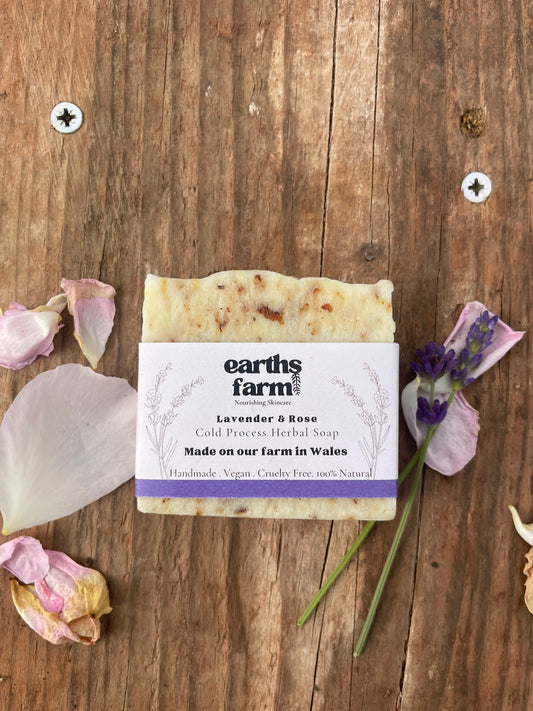 Bar of soap with a label on a wooden surface with lavender flowers